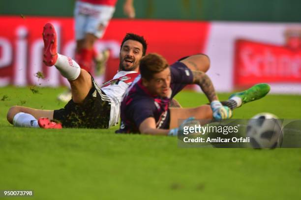 Ignacio Scocco of River Plate fights for the ball with Maximiliano Velazco goalkeeper of Arsenal during a match between Arsenal and River Plate as...