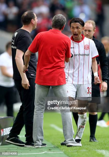 Takashi Usami of Duesseldorf reacts after his substitution of head coach Friedhelm Funkel of Duesseldorf during the Second Bundesliga match between...