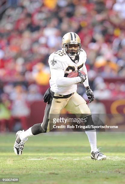 Reggie Bush of the New Orleans Saints runs with the ball against the Washington Redskins at FedExField on December 6, 2009 in Landover, Maryland. The...