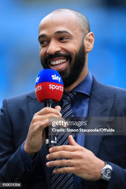 Sky Sports pitchside pundit Thierry Henry laughs during the Premier League match between Manchester City and Swansea City at the Etihad Stadium on...