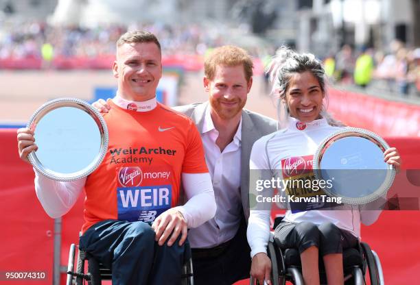 Britain's Prince Harry poses with the elite men's and women's wheelchair winners Britain's David Weir and Australia's Madison de Rozario at the 2018...