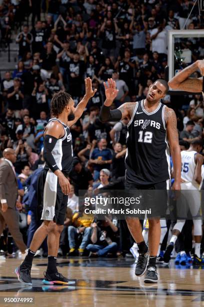 Patty Mills and LaMarcus Aldridge of the San Antonio Spurs react to a play in Game Four of the Western Conference Quarterfinals against the Golden...