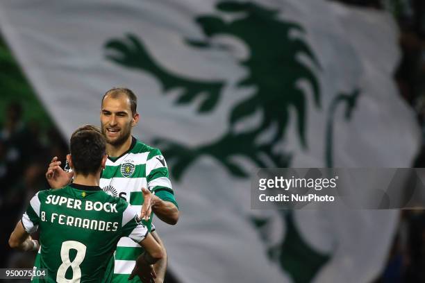 Sporting's Dutch forward Bas Dost celebrates with team mates after scoring a goal during the Portuguese League football match between Sporting CP and...