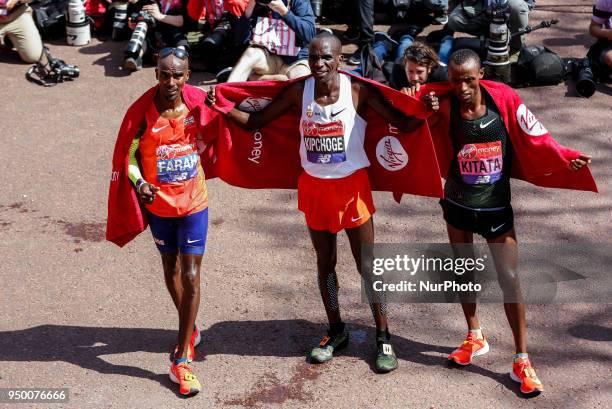 Mo Farrah from Great Britain , Eliud KIPCHOGE from Kenia , Tola Shula KITATA from Ethiopia pose in front of reporters at the finish line during the...