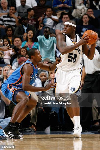 Zach Randolph of the Memphis Grizzlies looks to pass over D.J. White of the Oklahoma City Thunder during the game on December 11, 2009 at FedExForum...