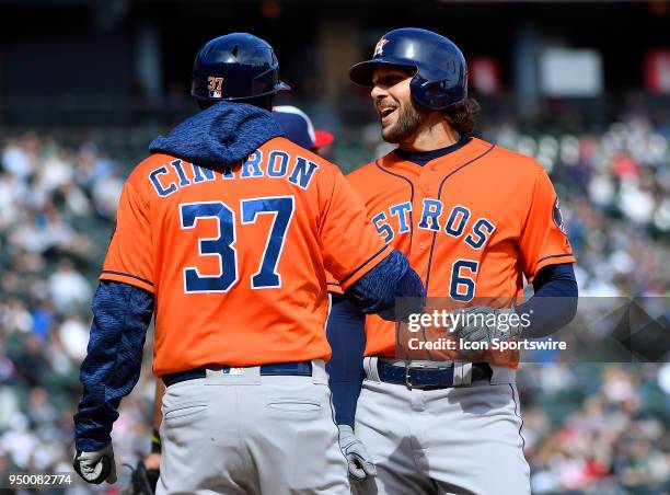 Houston Astros first base coach Alex Cintron and Houston Astros center fielder Jake Marisnick celebrate at first base during game against the Chicago...