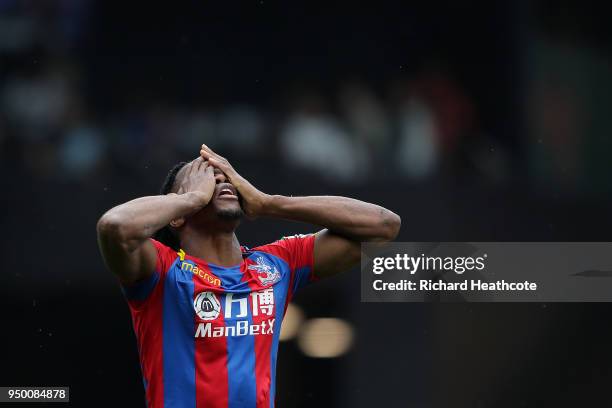 Wilfred Zaha of Palace reacts after getting a yellow card during the Premier League match between Watford and Crystal Palace at Vicarage Road on...