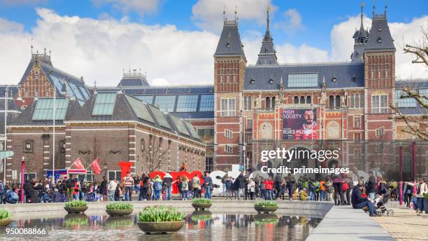 amsterdam outside rijksmuseum tourists walk on the street (ed) - basilica of st nicholas amsterdam stock pictures, royalty-free photos & images