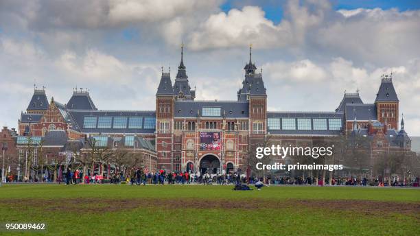 amsterdam outside rijksmuseum tourists walk on the street (ed) - basilica of st nicholas amsterdam stock pictures, royalty-free photos & images