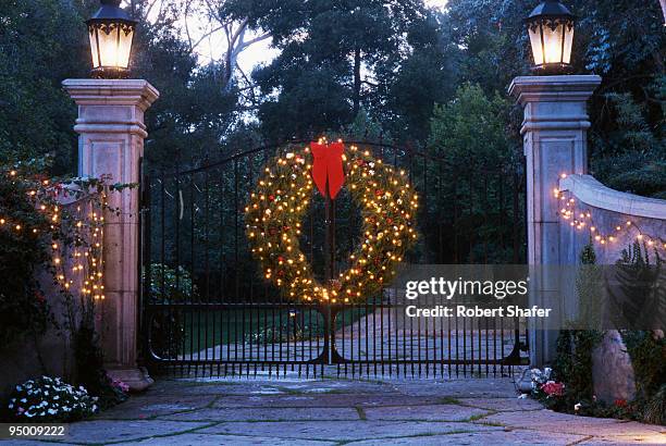 driveway with gate and holiday wreath - driveway gate stock pictures, royalty-free photos & images