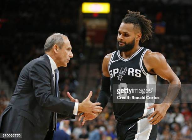 Ettore Messina greets Patty Mills of the San Antonio Spurs during the game against the Golden State Warriors in the second half of Game Four of Round...