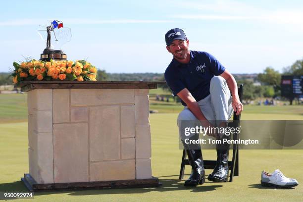 Andrew Landry puts on the Champion's Boots after winning the Valero Texas Open at TPC San Antonio AT&T Oaks Course on April 22, 2018 in San Antonio,...