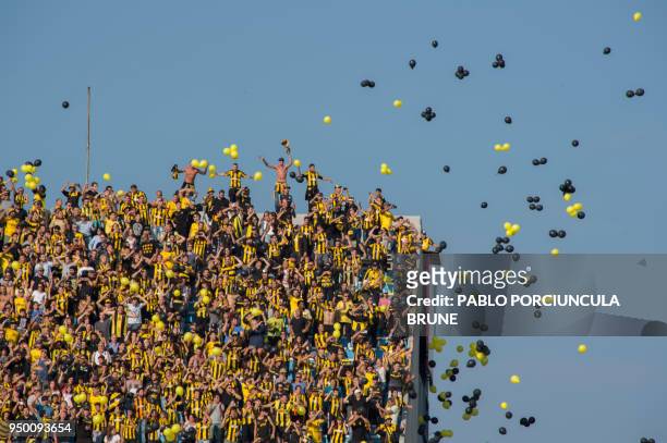 Penarol's fans cheers their team during the Uruguay's football match derby against Nacional at the Centenario stadium in Montevideo on April 22, 2018.
