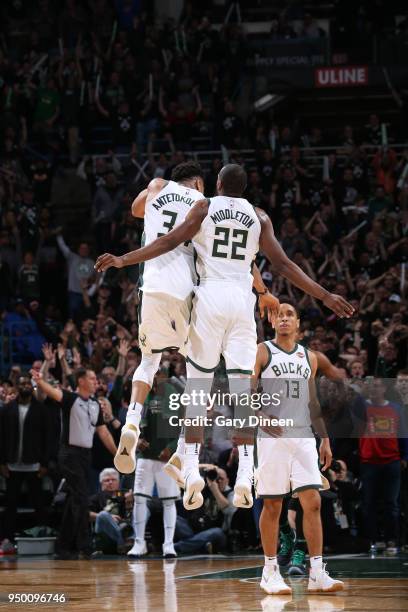Giannis Antetokounmpo of the Milwaukee Bucks and Khris Middleton of the Milwaukee Bucks celebrate during the game against the Boston Celtics in Game...