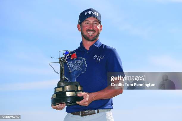 Andrew Landry holds the Valero Texas Open trophy for a photo after the final round of the Valero Texas Open at TPC San Antonio AT&T Oaks Course on...