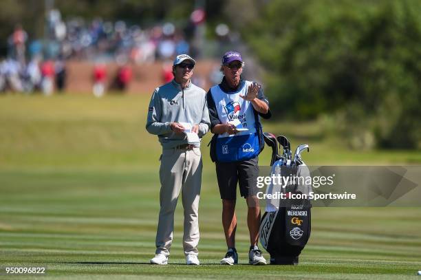 Richy Werenski discusses a shot with his caddie during the final round of the Valero Texas Open at the TPC San Antonio Oaks Course in San Antonio, TX...