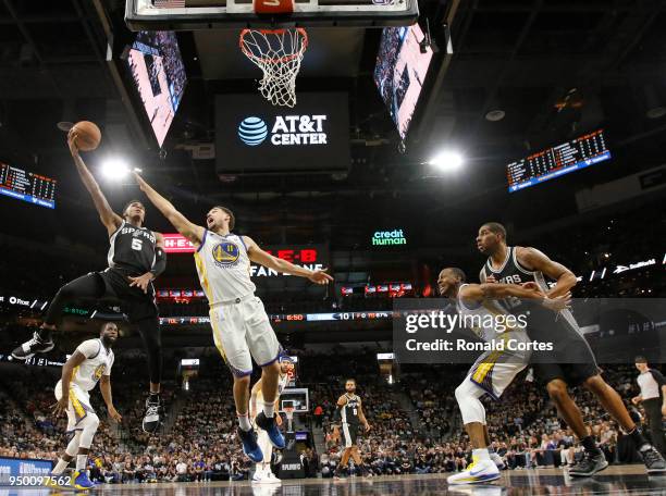 Dejounte Murray of the San Antonio Spurs shoots over Klay Thompson of the Golden State Warriors in the first half of Game Four of Round One of the...