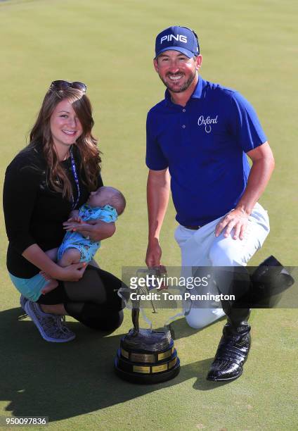Andrew Landry poses with the Valero Texas Open trophy and his wife, Elizabeth and his son, Brooks, after he won the Valero Texas Open at TPC San...