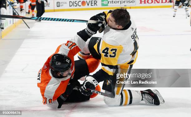 Travis Konecny of the Philadelphia Flyers scuffles with Conor Sheary of the Pittsburgh Penguins in the third period in Game Six of the Eastern...