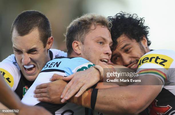 Matt Moylan of the Sharks is tackled by Isaah Yeo and Corey Harawira-Naera of the Panthers during the round seven NRL match between the Cronulla...