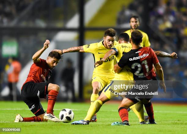 Nahitan Nandez of Boca Juniors fights for the ball with Hernan Bernardello of Newells Old Boys during a match between Boca Juniors and Newell's Old...