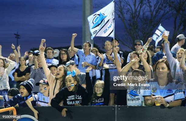 Sharks fans cheer a try during the round seven NRL match between the Cronulla Sharks and the Penrith Panthers at Southern Cross Group Stadium on...