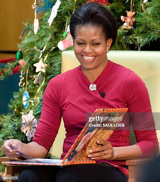 First Lady Michelle Obama reads "'Twas the Night Before Christmas" to children alonsgide dog Bo during a visit to the Childrenís National Medical...