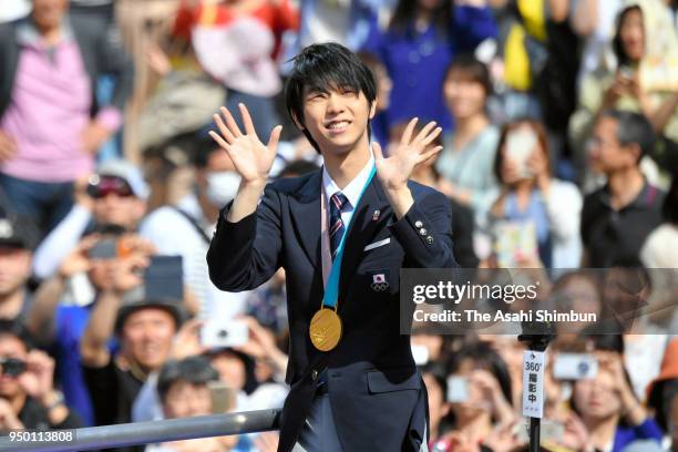 Sochi and PyeongChang Winter Olympic Games Figure Skating Men's Single gold medalist Yuzuru Hanyu waves to supporters during the parade on April 22,...