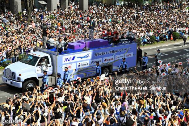 Sochi and PyeongChang Winter Olympic Games Figure Skating Men's Single gold medalist Yuzuru Hanyu waves to supporters during the parade on April 22,...