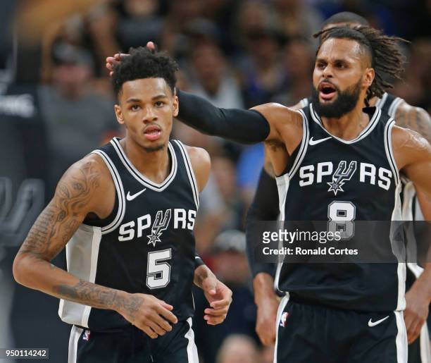 Patty Mills of the San Antonio Spurs congratulates Dejounte Murray after a basket against the Golden State Warriors In the second half of Game Four...