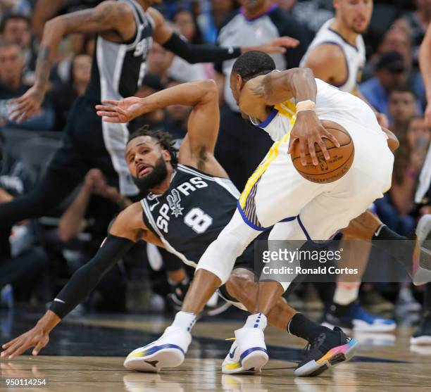 Patty Mills of the San Antonio Spurs tries to draw a charge against Andre Iguodala of the Golden State Warriors in the first half of Game Four of...