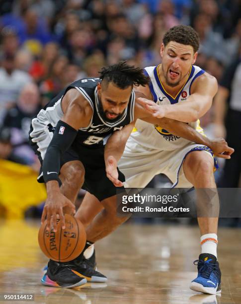 Patty Mills of the San Antonio Spurs is pressured by Klay Thompson of the Golden State Warriors In the second half of Game Four of Round One of the...