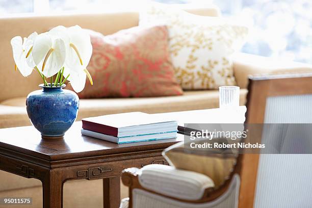 anthuriums in vase on coffee table - coffee table stock pictures, royalty-free photos & images