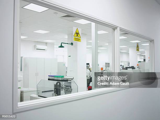 biohazard sticker on laboratory window - biohazard symbol stockfoto's en -beelden