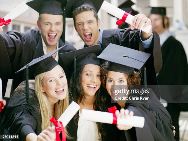 graduates holding diplomas - animated graduation cap stock pictures, royalty-free photos & images