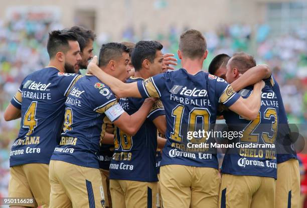 Marcelo Diaz of Pumas celebrates with teammates after scoring the first goal of his team during the 16th round match between Santos Laguna and Pumas...