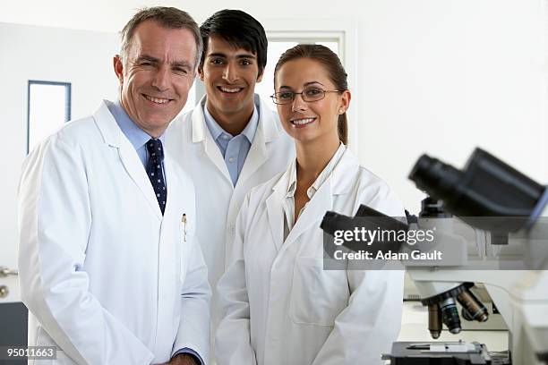 smiling scientists in laboratory - adam gault stock pictures, royalty-free photos & images