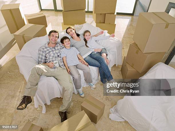 familie leg dich auf die couch, umgeben von pappe boxen - family on couch with mugs stock-fotos und bilder