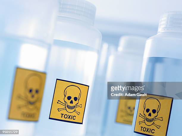bottles with toxic labels - toxin stockfoto's en -beelden