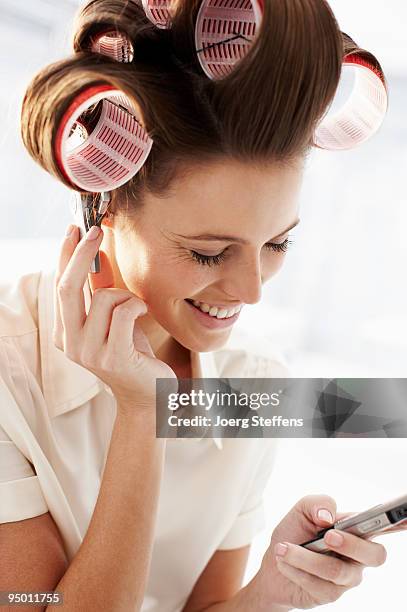 woman in curlers talking on cell phone - papiljott bildbanksfoton och bilder