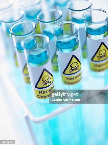 close up of test tubes with toxic labels - chemical hazard symbol stock pictures, royalty-free photos & images