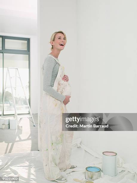 pregnant woman painting nursery - full body paint stock pictures, royalty-free photos & images