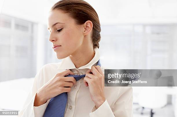 businesswoman loosening tie - no tie stock pictures, royalty-free photos & images