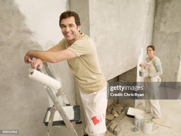 couple painting living room - ladder leaning stock pictures, royalty-free photos & images