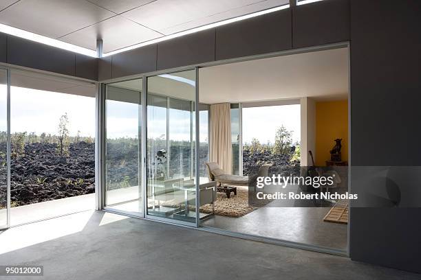 modern house overlooking volcanic rock - sliding door imagens e fotografias de stock