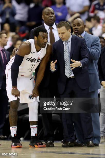 John Wall of the Washington Wizards talks with head coach Scott Brooks in the second half of the Wizard s106-98 win over the Toronto Raptors during...