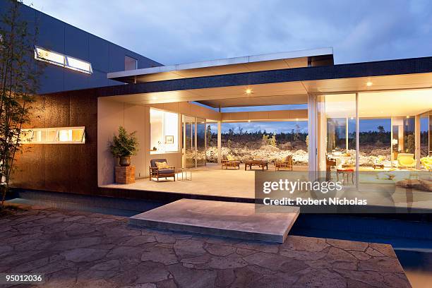 illuminated modern house - luxury home exterior stock-fotos und bilder