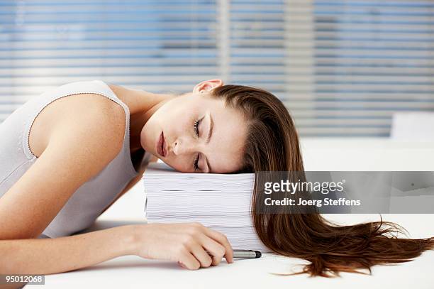 businesswoman sleeping on stack of papers - overdoing stock pictures, royalty-free photos & images