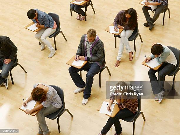 college students taking test in classroom - moving activity stock pictures, royalty-free photos & images