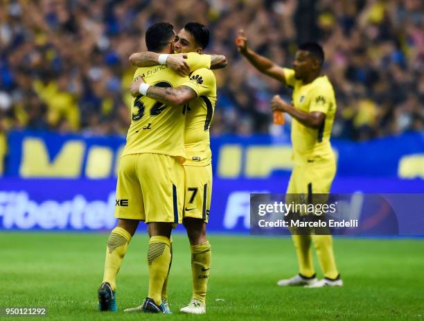 Cristian Pavon of Boca Juniors celebrates with Carlos Tevez after scoring the third goal of his team during a match between Boca Juniors and Newell's...